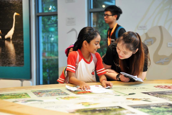 A volunteer interacting with a child in the museum.