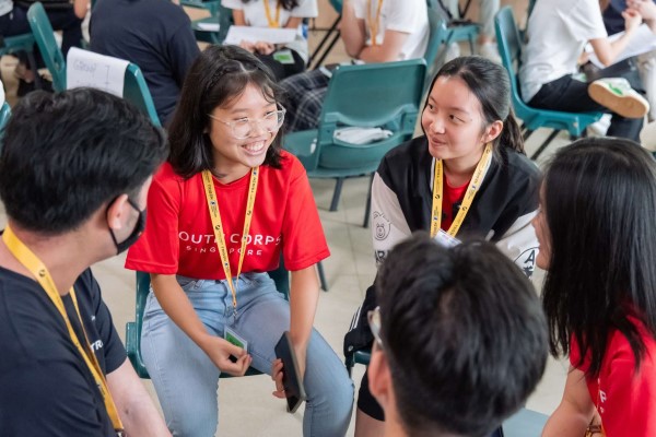 Five volunteers engaging in a conversation.